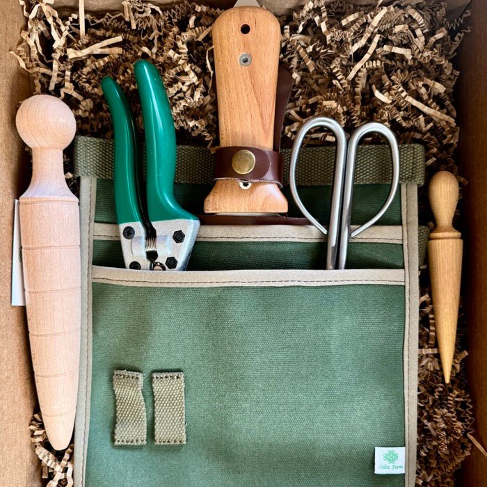 Set of gardening tools including pruners, shears, and a wooden tool in a green fabric pouch.