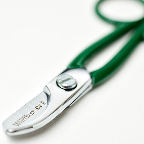 Green-handled scissors with 'Whiteley 332' branding on a white background